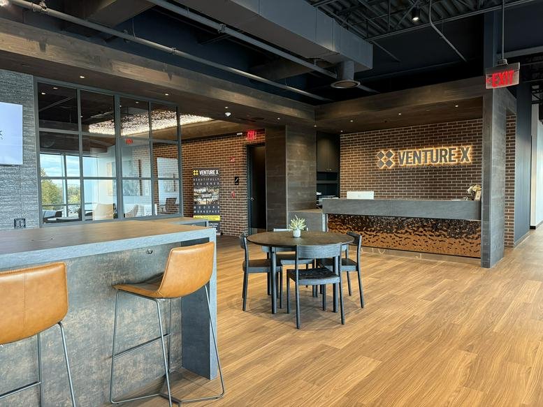Spacious communal area at 7100 Guilford Drive featuring a branded reception desk and wood floors.