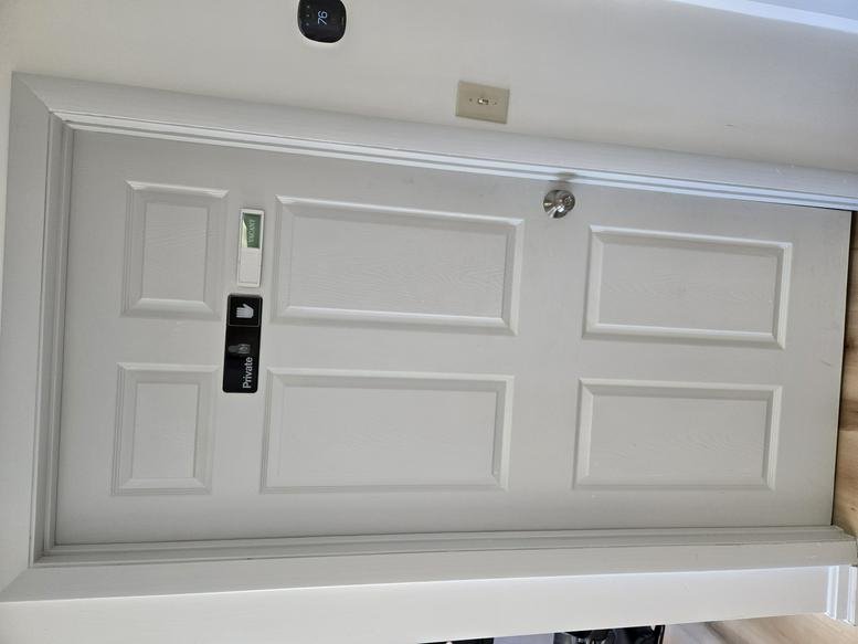 White paneled entrance door to 716 West Boylston Street, Worcester (Massachusetts) with an electronic lock.
