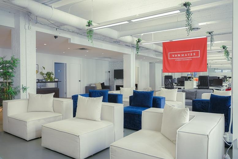 Vibrant lobby and lounge at 717 West Pender Street with colorful seating and branded flag.