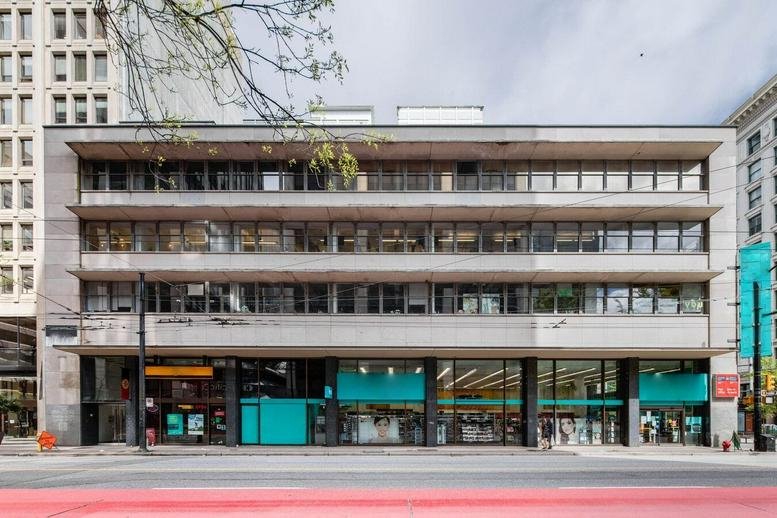 The low-rise stone and glass exterior facade of 717 West Pender.