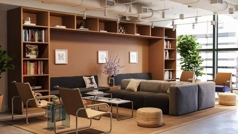 Spacious communal lounge at 7272 Wisconsin Avenue, The Wilson, featuring a large bookshelf and plush seating.