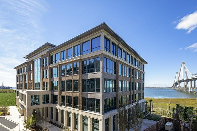 Exterior view of the contemporary glass and stone building at 75 Port City Landing, Suite 110.