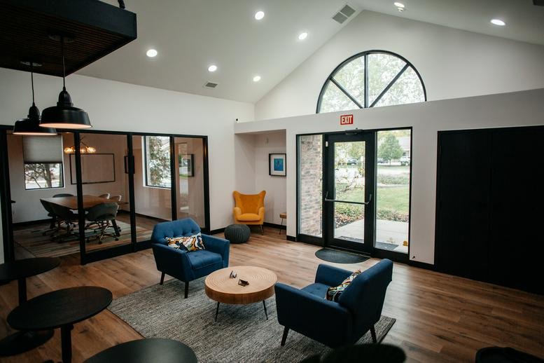 Spacious reception lounge at 7510 East 82nd Street with vaulted ceilings and blue armchairs.