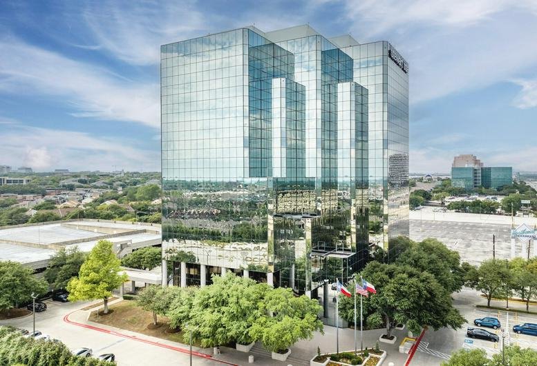 Aerial view of the polished glass office building at 7550 Interstate 10 West.