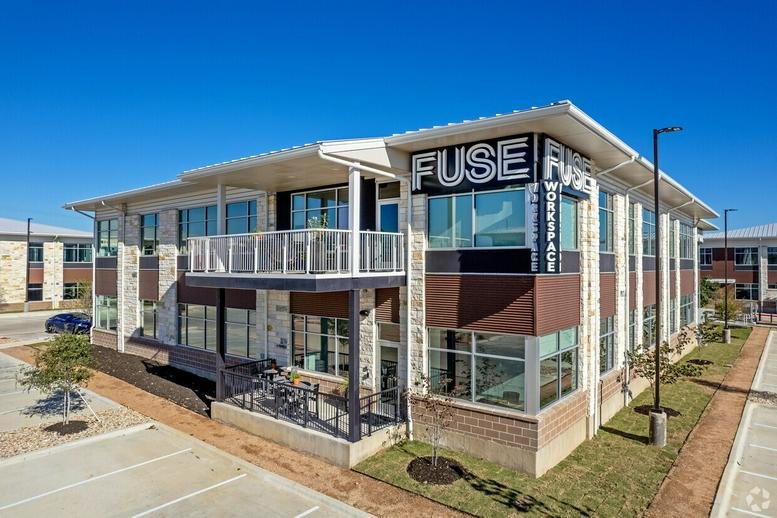 Exterior view of the modern stone and glass FUSE Workspace building at 7710 N FM 620, Building 13-D.