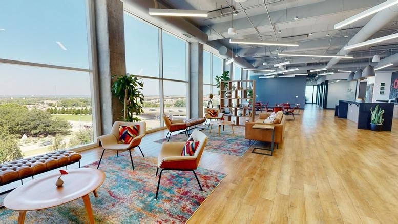 Spacious communal lounge featuring colorful rugs, leather sofas, and wide window views.