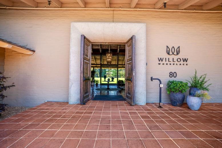 Main entrance of 80 Willow Road, Menlo Park featuring heavy wooden doors and tiled flooring.