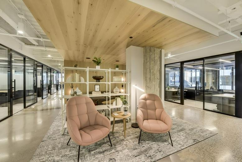 Bright lobby at 801 South Marquette Avenue with pink velvet armchairs and wood paneled ceiling.