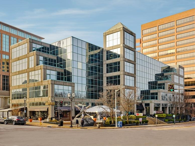 Exterior view of the glass and stone building facade at 8112 Maryland Avenue.