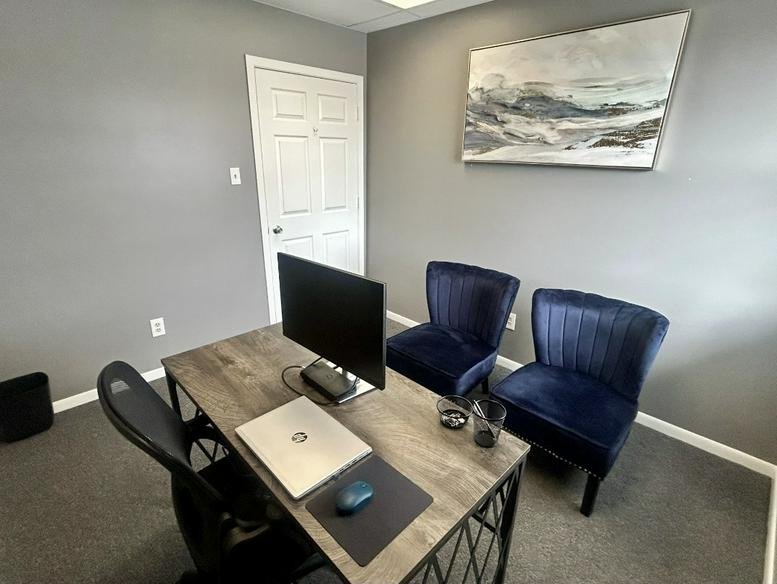 Office workspace at 8231, Hohman Avenue, Suite 200 2nd floor, Munster featuring a wooden desk and blue velvet chairs.
