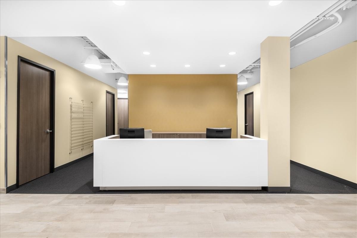 Sleek white reception desk at 830 Morris Turnpike, 4th Floor, Short Hills, New Jersey.