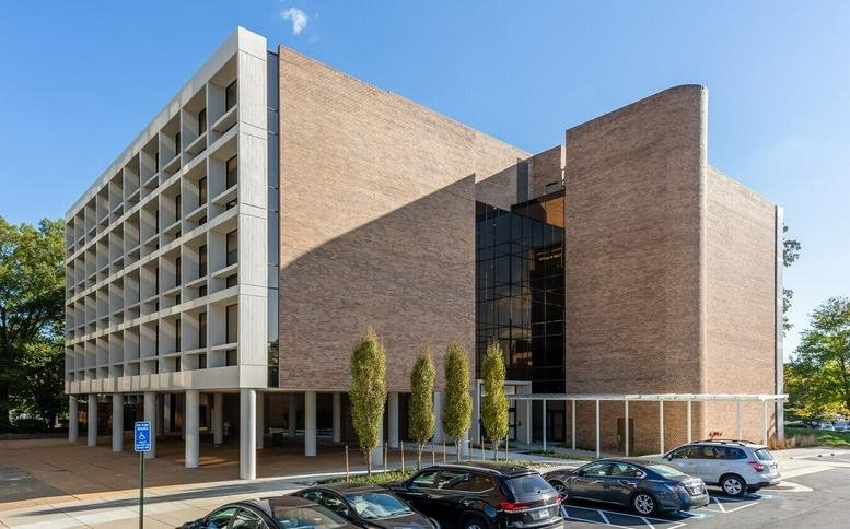 Exterior view of the brick and glass office building at 8320 Old Courthouse Road, Suite 500.