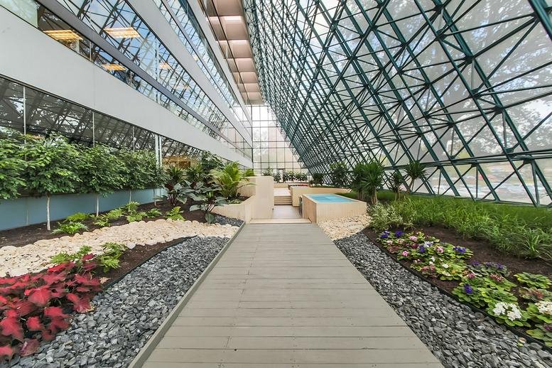Bright indoor garden walkway at 84 Northeast Loop 410, Floor 2, San Antonio, Texas.