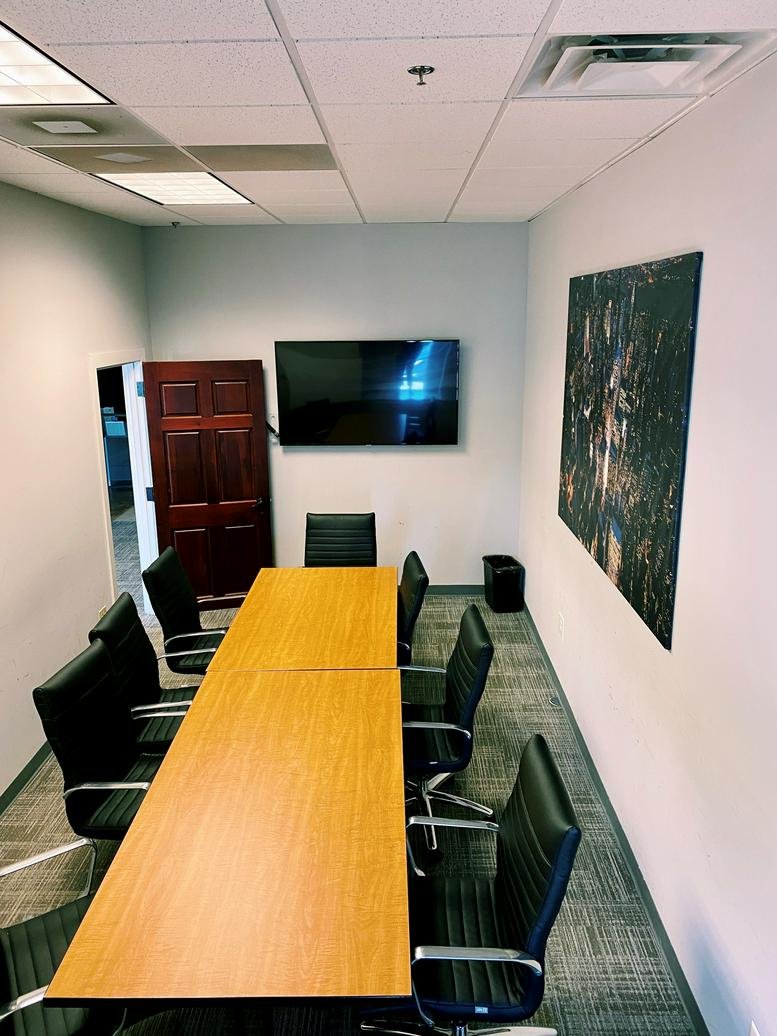 Professional meeting room at 840 1st Avenue, Suite 400, King of Prussia, Pennsylvania with a large wood table and TV.