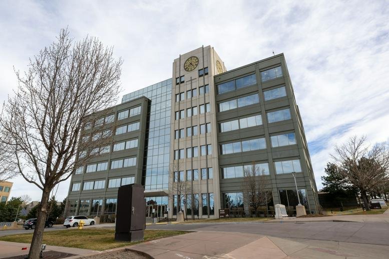 Exterior view of the multi-story glass and concrete building at 8400 East Crescent Parkway.