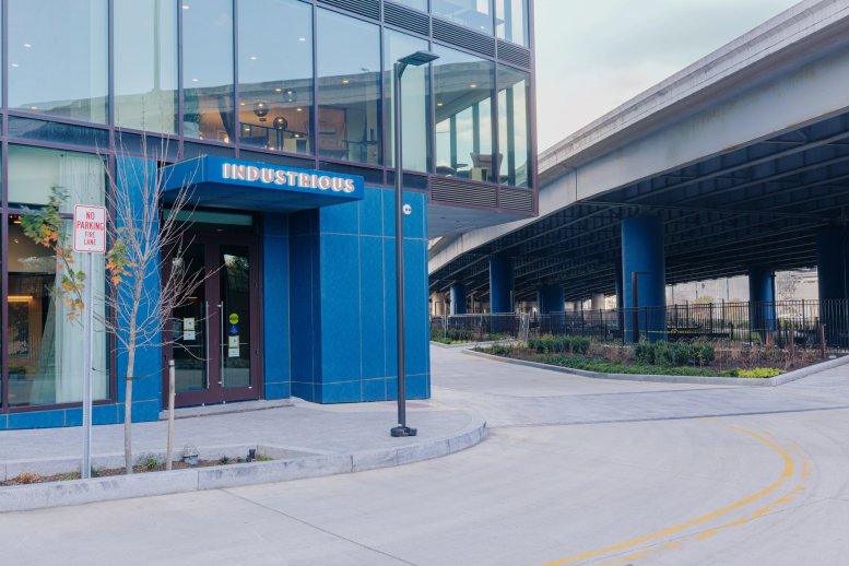 Exterior entrance of Industrious at 853 New Jersey Avenue SE featuring a blue facade and glass windows.