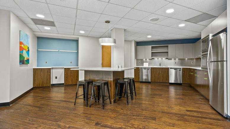 Spacious communal kitchen and dining area at 888 Worcester Road, Wellesley Hills, Massachusetts.
