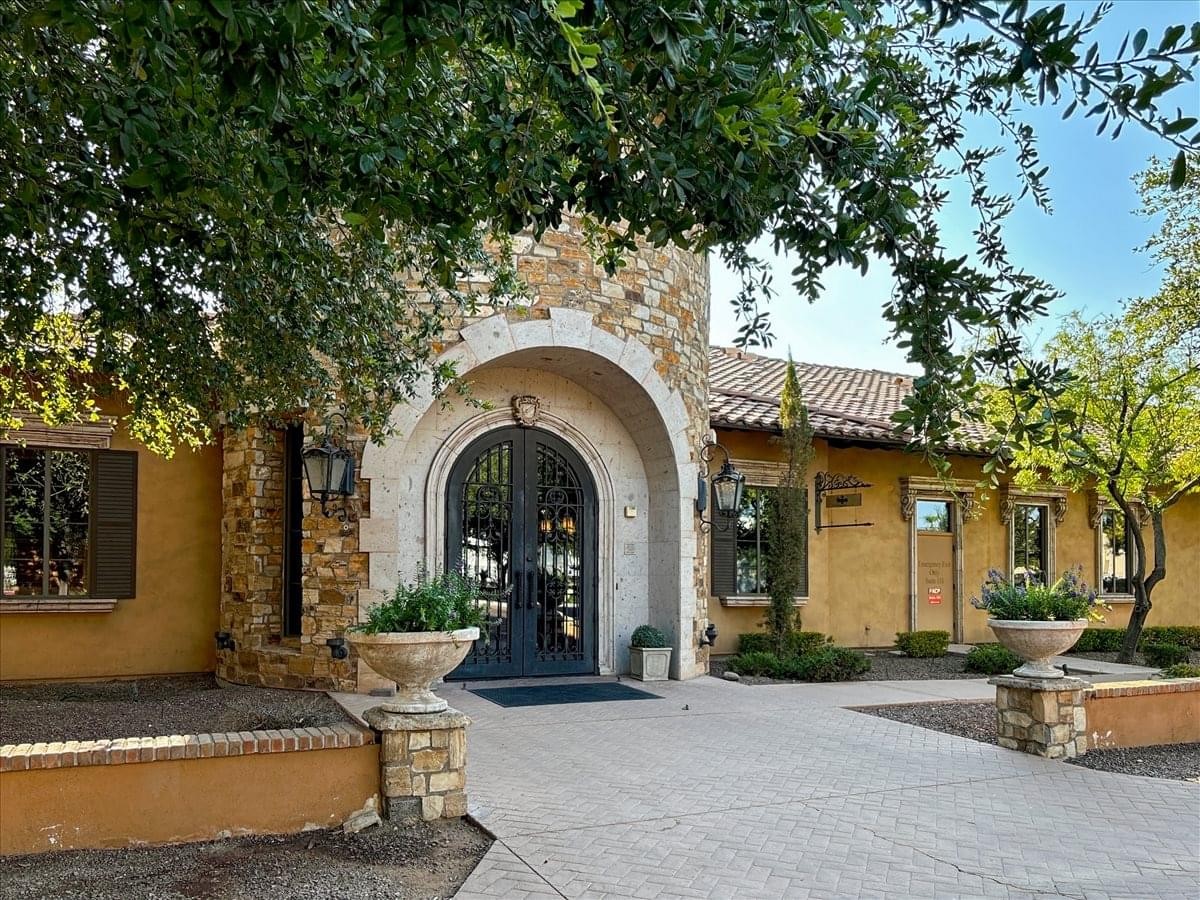 Exterior stone facade and arched entrance of the office at 890 West Elliot Road.