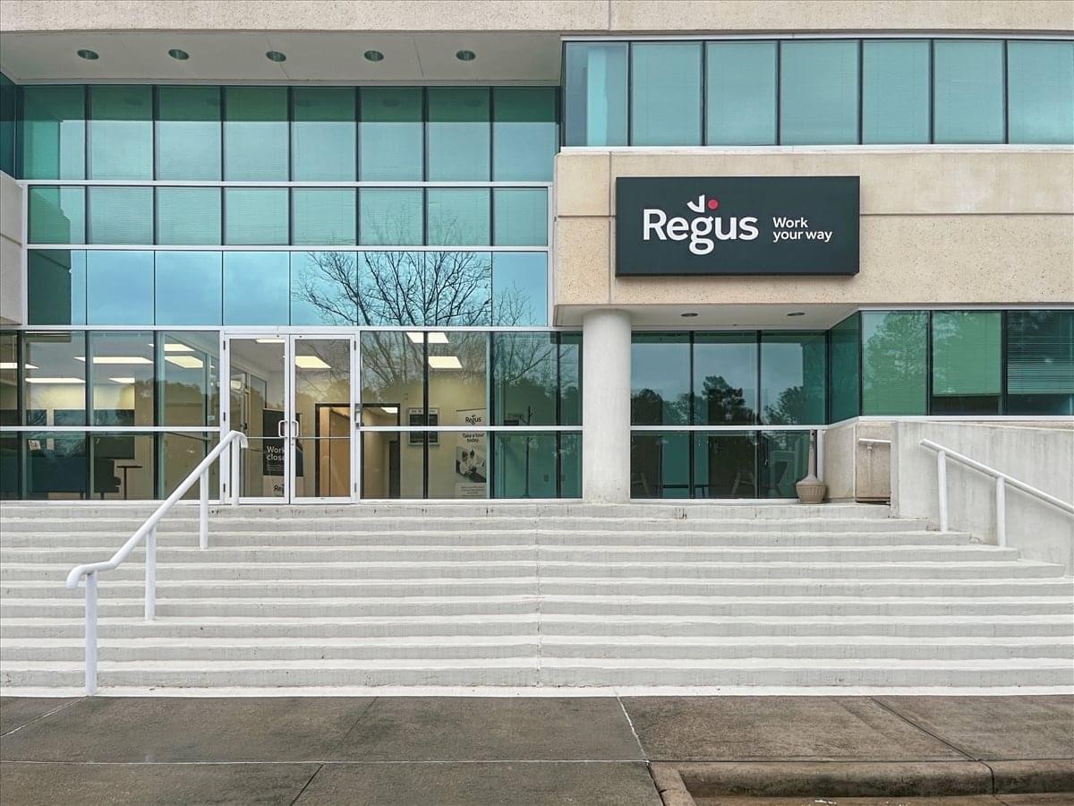 Modern glass and stone exterior of the office building at 900 Trail Ridge Road.