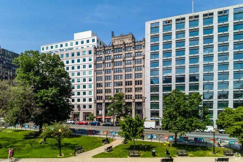 Exterior view of the historic facade at 910 17th Street Northwest overlooking a green park.