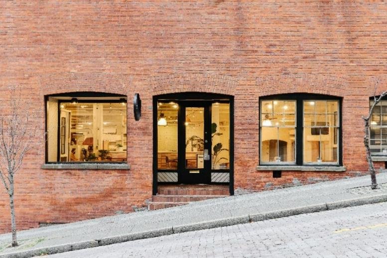 Street-level view of the brick facade and arched entry at 92 Lenora Street.