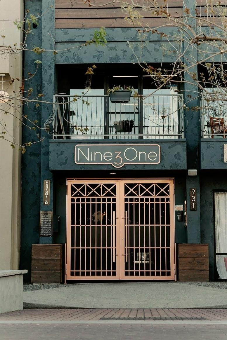 Exterior view of Nine3One building with a gated entrance.