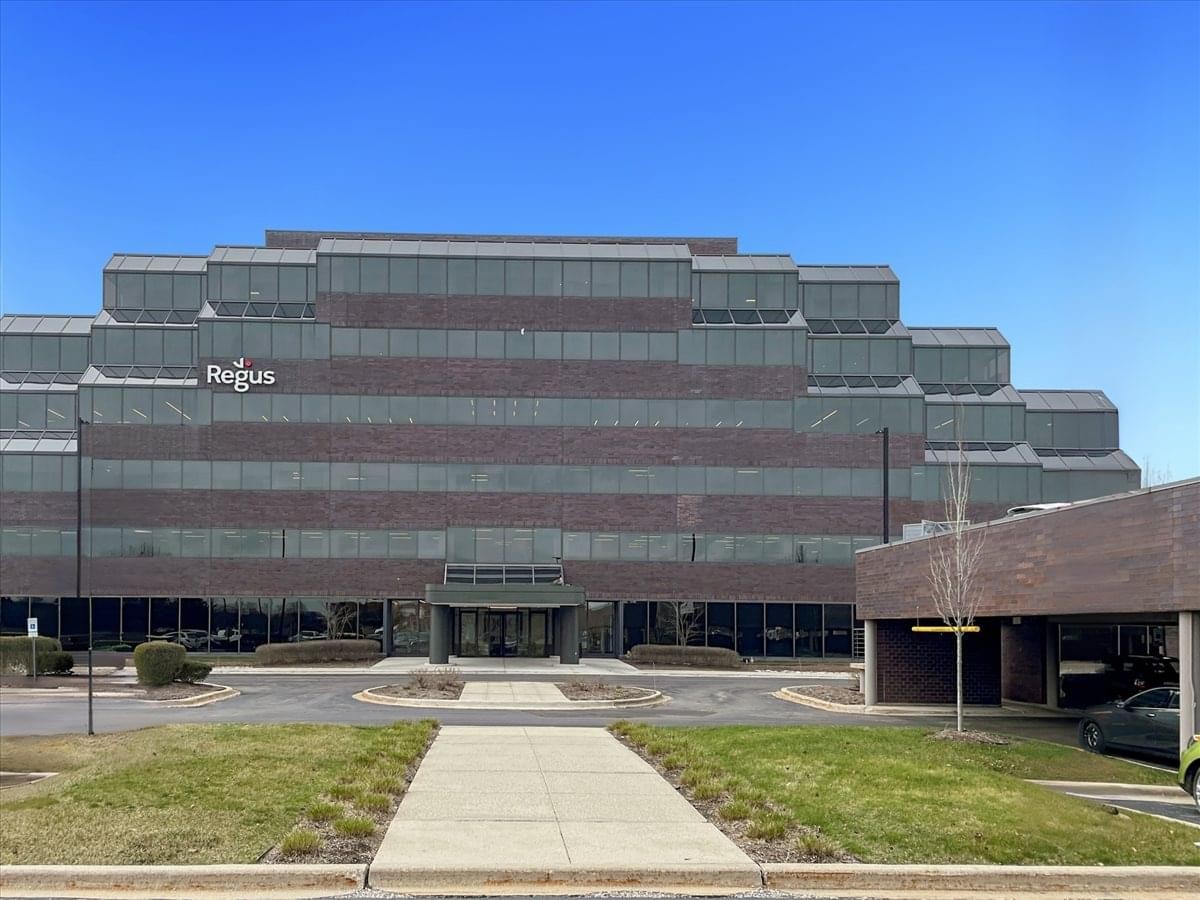 Exterior view of the tiered brick and glass building at 999 Oakmont Plaza Dr.