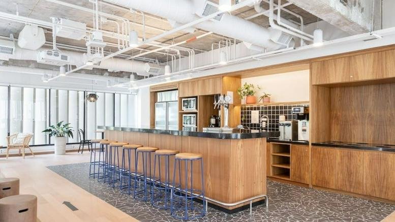 Modern wooden café and breakout area with bar seating at Alameda Rio Claro 241, Bela Vista, Sao Paulo.