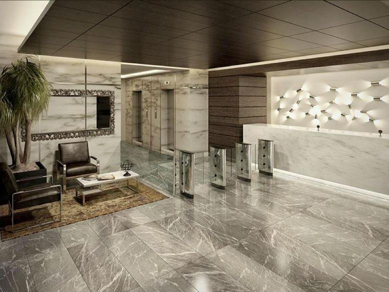 Elegant lobby with marble floors and a unique bubble-like wall light installation at Anillo Periférico 2165.