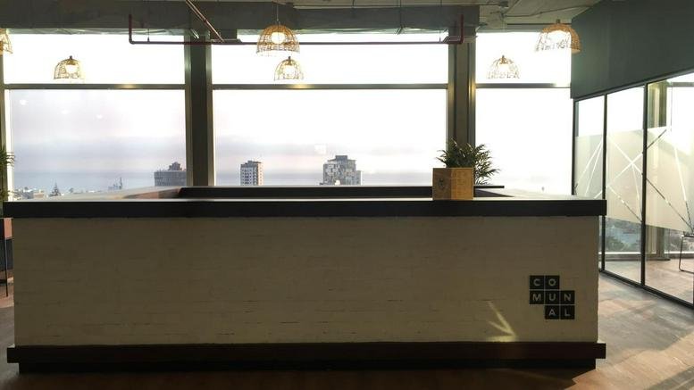 Reception desk at Avenue Alberto Del Campo 411, Piso 10, Magdalena with large windows overlooking the city.