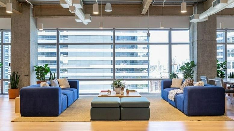 Spacious lounge at Av. Das Nações Unidas 14261 with blue sofas, potted plants, and large windows.