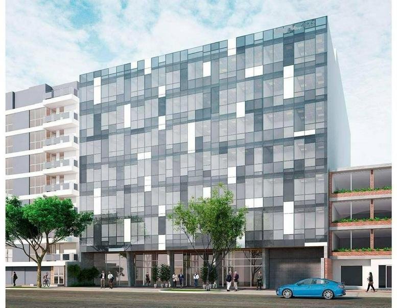 Exterior view of the modern glass-facade building at Avenue Emilio Cavenecia 151.