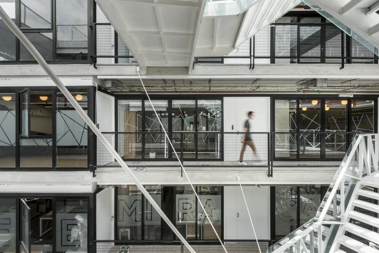 Industrial-style atrium and walkway of the Av Grau 629 Barranco building.