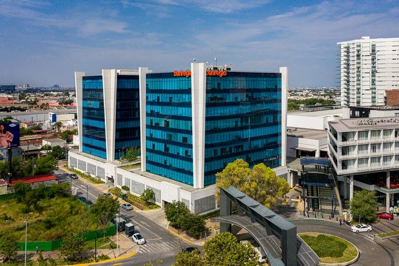 Exterior view of the blue glass facade building at Av. Revolución 2703, Ladrillera, Nuevo Sur, Monterrey.