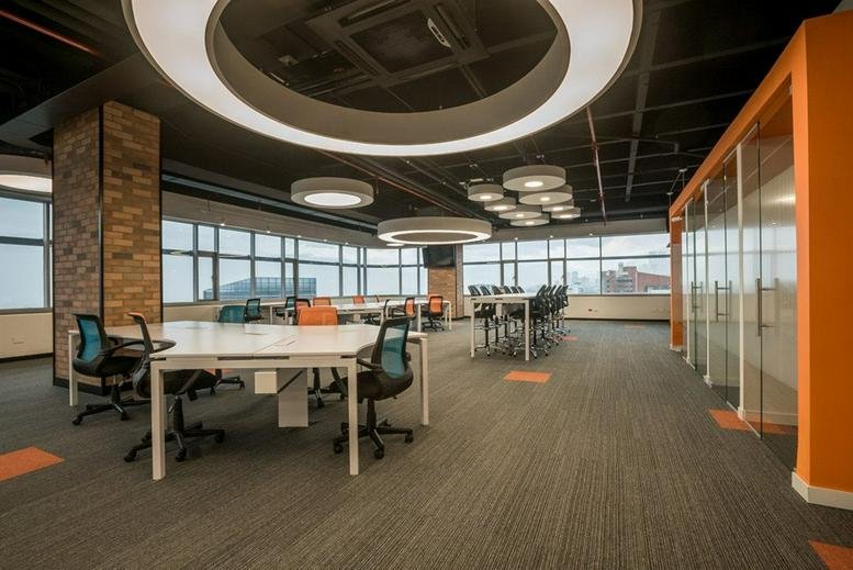 Large open-plan workspace at Avenida El Poblado, Carrera 42 Nº 3 Sur 81 with modern circular lighting.