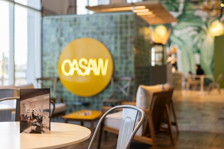 Bright lobby area featuring the Oasaw logo on a teal tiled wall.