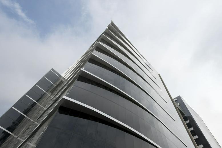 Exterior view of the glass-facade Avenida Manuel Olguín 327 building.