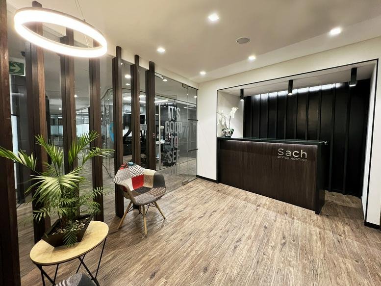 Wooden reception desk with modern halo lighting at Avenida Tamaulipas 141, Piso 3 y 5, Condesa.