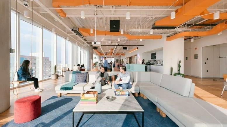 Spacious communal lounge at Blas Parera 3551, Olivos, Buenos Aires with floor-to-ceiling windows and orange ceiling accents.