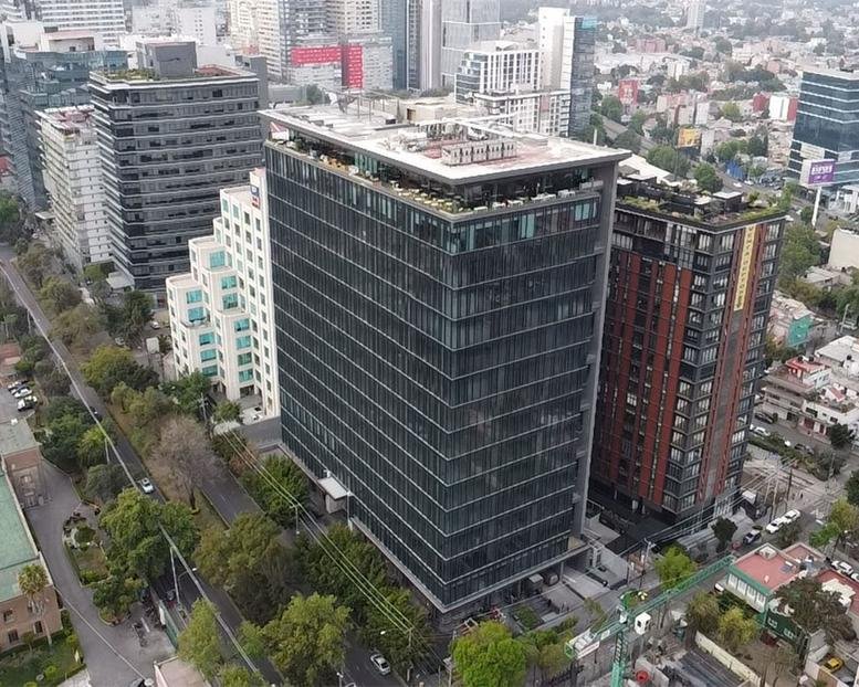 Aerial exterior view of the modern glass building at Boulevard Miguel de Cervantes Saavedra 161.