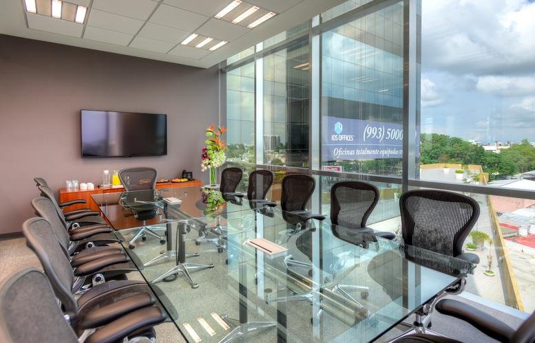 Modern boardroom at Boulevard Adolfo Ruiz Cortines 1344 featuring a glass table and city views.