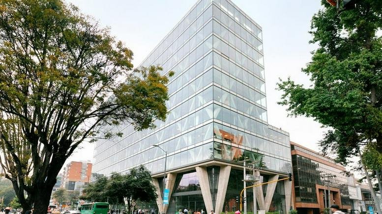 Exterior view of the glass-facade building at Calle 81 No. 11-08 with prominent V-shaped supports.