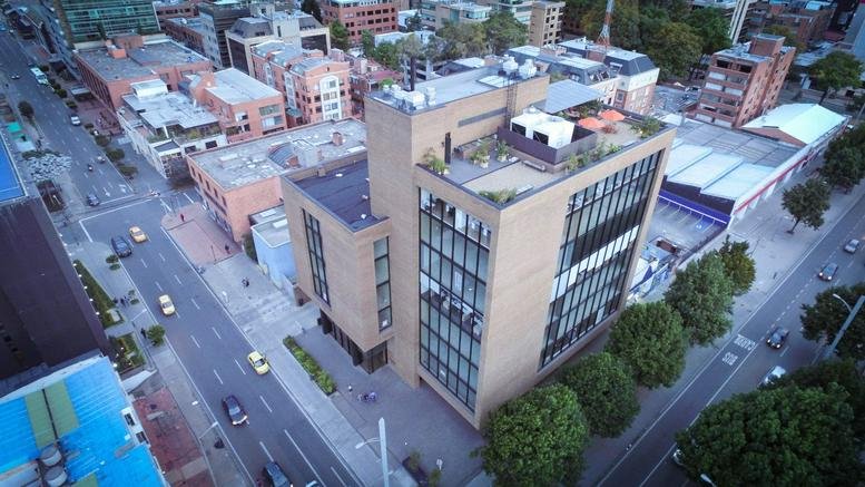 Aerial exterior view of the modern brick and glass Calle 95 No 14-45 Penthouse building.