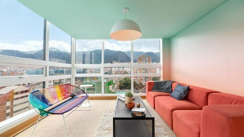 Spacious communal lounge at Carrera 12a No. 78-40, Bogota with a red sofa and city views.