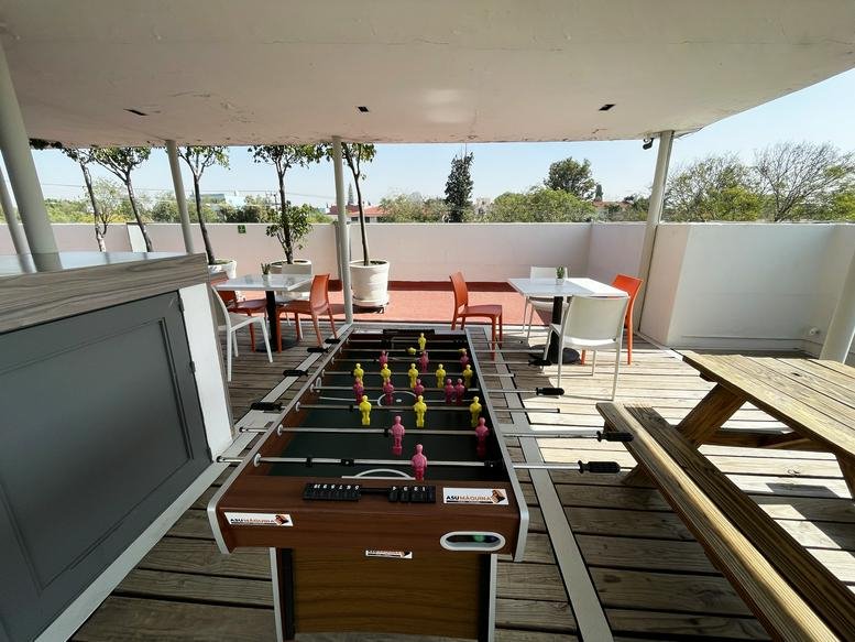 Outdoor terrace break area featuring a foosball table and dining sets.