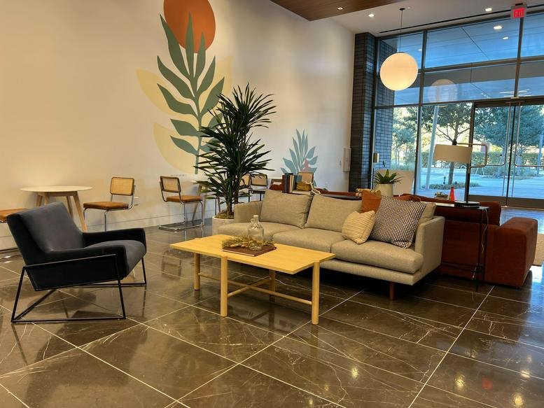 Lobby at City Place, 1401 Lake Plaza Drive with modern seating and a large botanical mural.