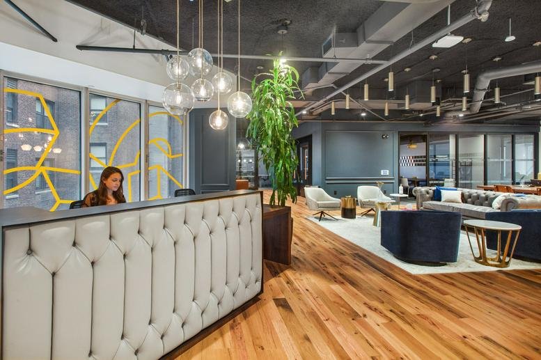 Reception lobby at CitySpire, 2nd & 3rd Floor, 156 West 56th Street featuring a tufted desk and globe pendant lights.