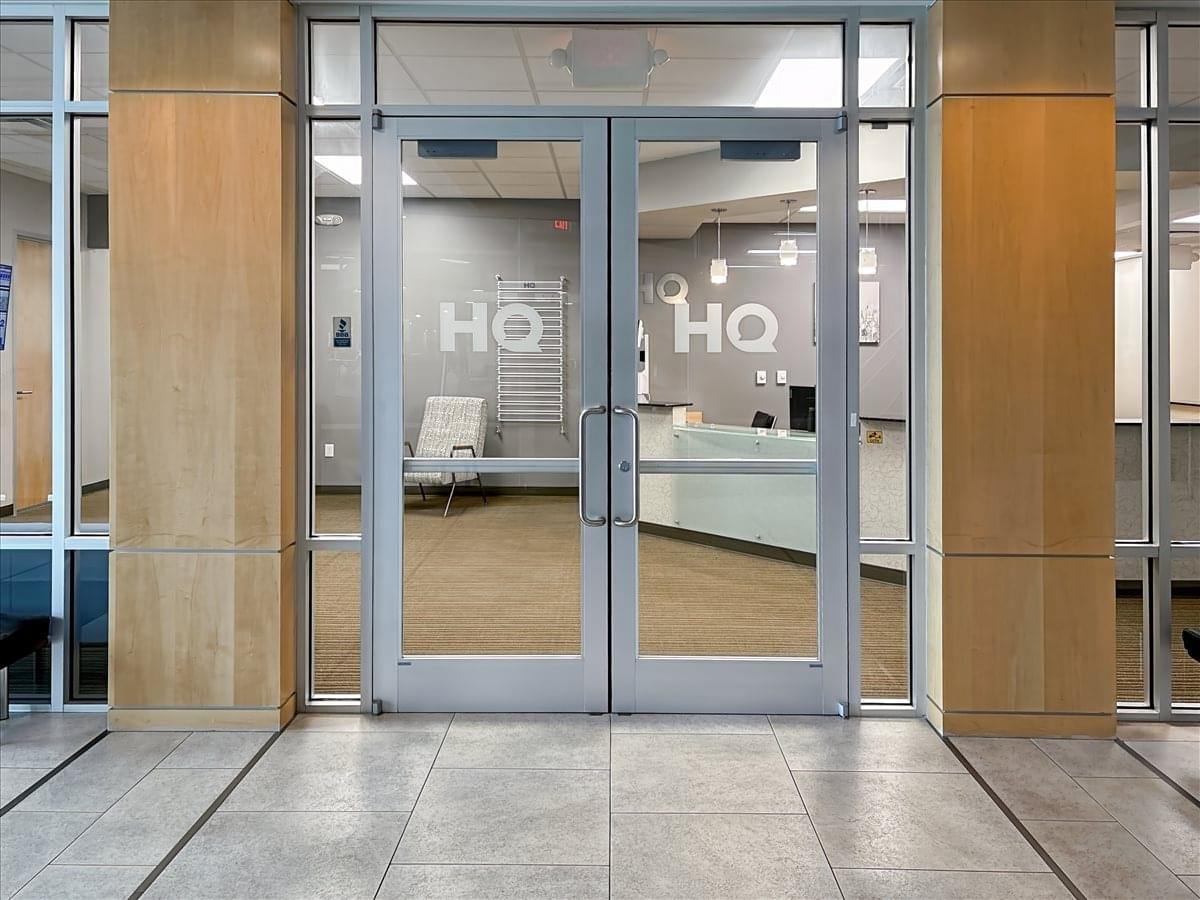 Main entrance to East Pointe 200 at 3420 Atrium Boulevard with glass double doors and a reception view.