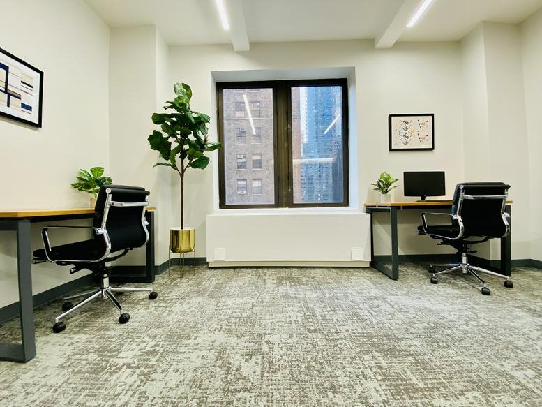 Spacious interior office at Grand Central, 353 Lexington Avenue, New York City with multiple desks and potted plants.