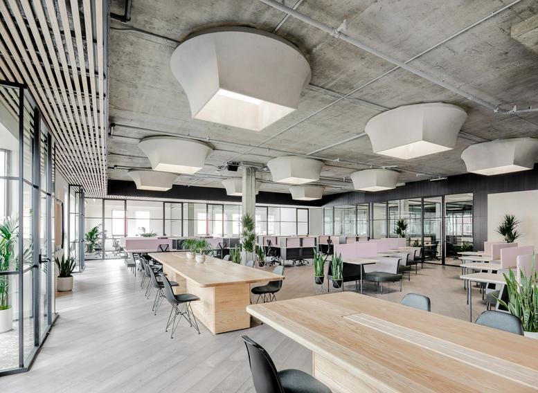 Spacious communal area at Jackson Square, 595 Pacific Avenue featuring wood tables and modern sculptural lighting.